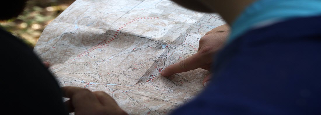 Picture of someone looking at a map on a table